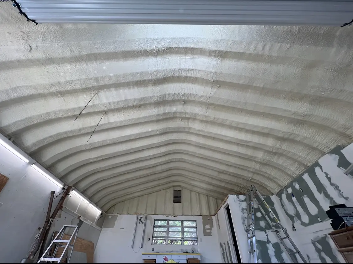 Spray polyurethane foam applied to the underside of a metal roof deck in Athens